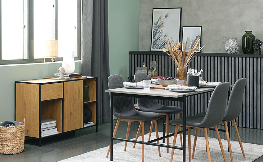 Jedilna miza v izgledu betona v jedilnici, sivi jedilniški stoli in omarica v barvi hrasta