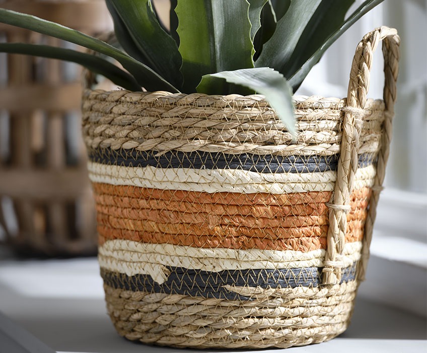 Pletena košara z detajli v oražni, črni in beli barvi 